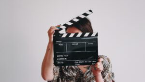 A person holding a film slate/clapper