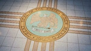 Seal of The State of New Mexico printed on a tile floor.