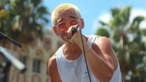 A portrait of Mato Wayahi singing into a microphone