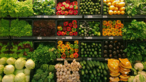 The produce section of a grocery store with rows of vegetables.