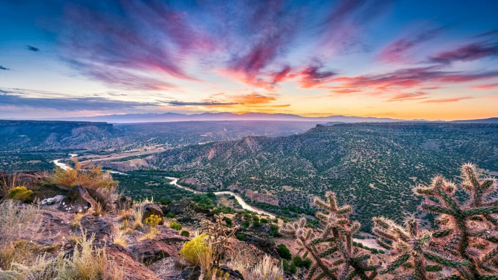 A vibrant photo of a sunset over New Mexico's landscape.