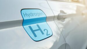 The side of a white car with a blue sticker that says "hydrogen h2."