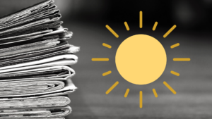 A stack of newspapers and a yellow cartoon sun.