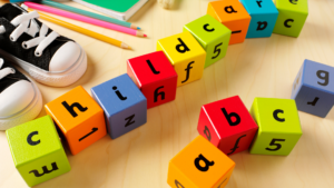 Childrens toys and objects with wooden blocks that spell out "childcare."