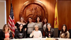Governor Michelle Lujan Grisham posing with a group of women after signing an executive action to protect abortions in New Mexico.