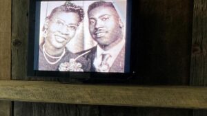 An photo of two people on a screen in the Facing the Rising Sun: The Journey of African American Homesteaders in NM exhibit.