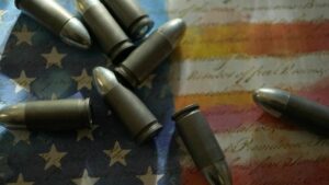 Bullets scattered on top of an american flag background.