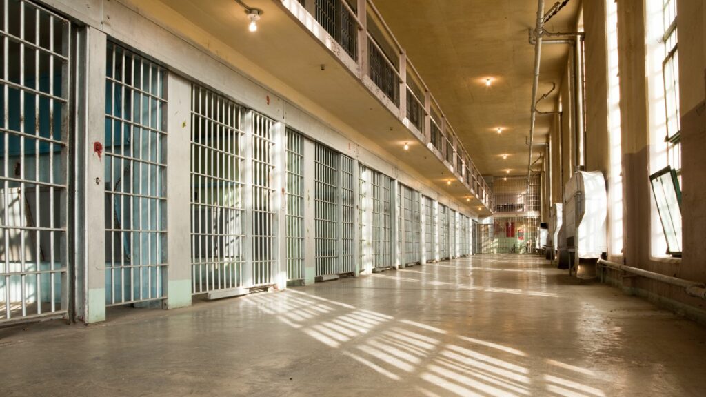 Jail cells with sunlight coming in through the windows.