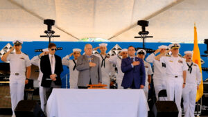 Navy Week in Albuquerque presentation with people in uniform saluting.