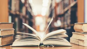 An open book on a table in a library.