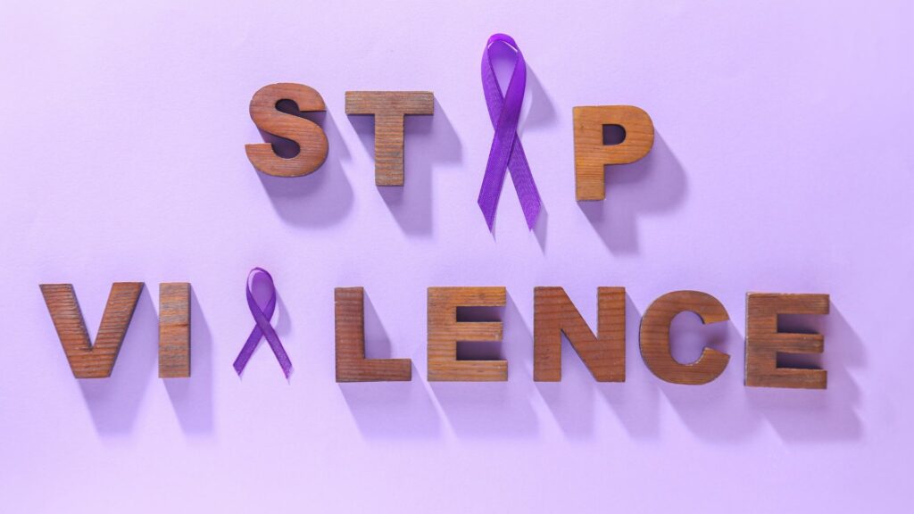 A collection of letters and purple ribbons that spell out "Stop Violence."