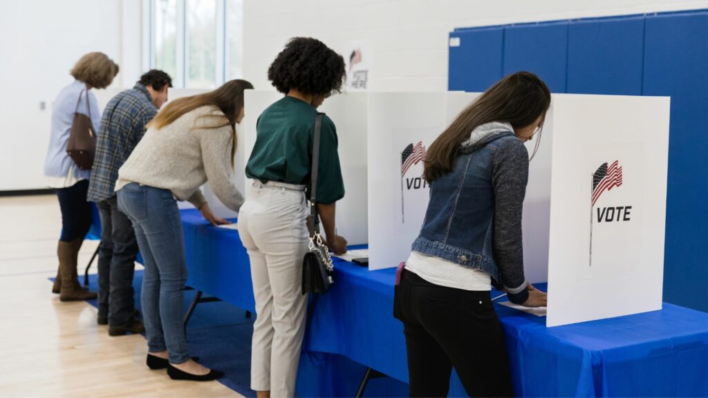 A row of people voting.