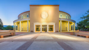 A building with a circular entrance at dusk.