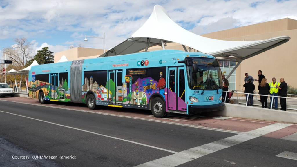 A colorful bus parked in front of a building.