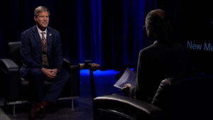 A man in a suit is talking to a man in a suit.