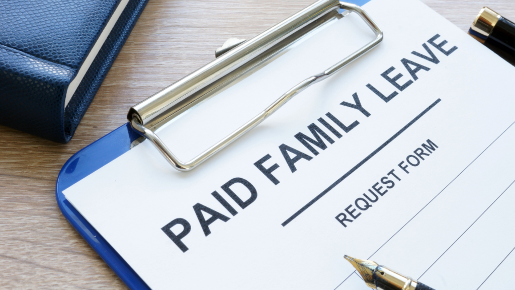 A clipboard with the word paid family leave on it.