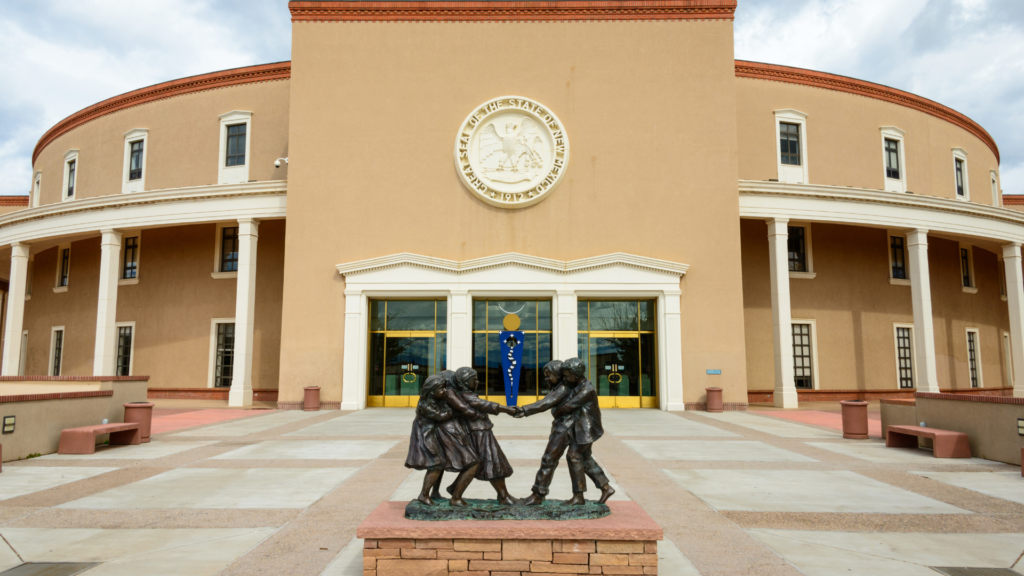 A statue of two people in front of a building.