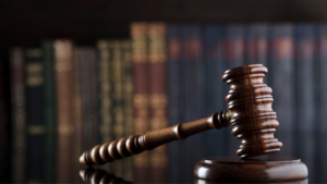 A gavel with books in the background.