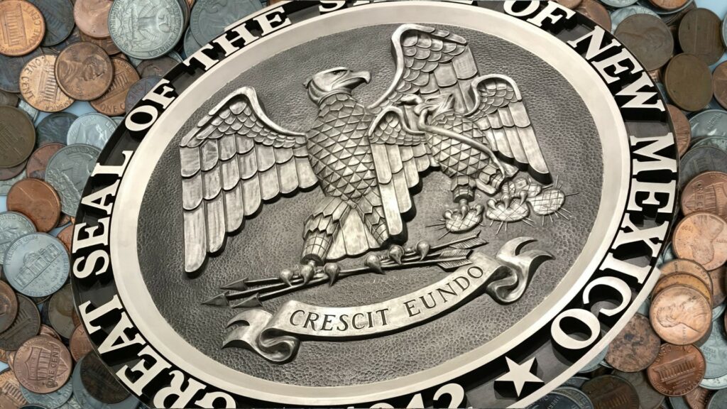 The new mexico state seal is surrounded by coins.