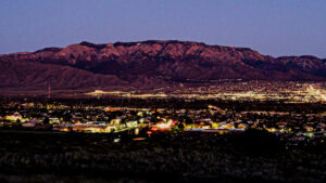 The Sandia mountains at sundown with the city lights.