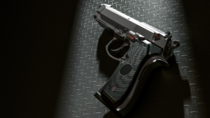 A gun is laying on a dark surface.