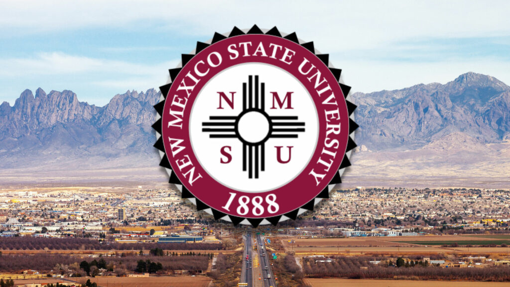 New mexico state university logo with mountains in the background.