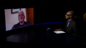 A man sitting in front of a television.