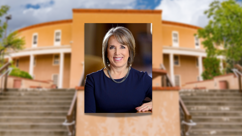 A woman is standing in front of a building with stairs.