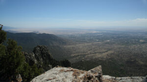 A view of a city from the top of a mountain.