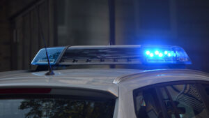 A police car with blue lights on top.