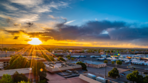 The sun is setting over a city.