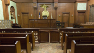 A wooden bench in a courtroom.