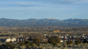 A view of a city with mountains in the background.