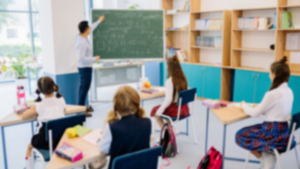 A group of children sitting at desks in a classroom.