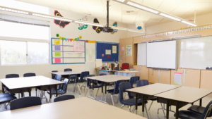 A classroom with tables and chairs.