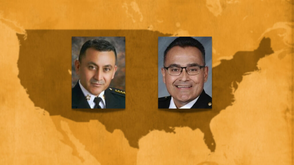 Two men are pictured in front of a map of the united states.