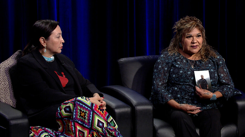 Two women sitting in chairs talking to each other.