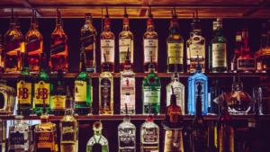 A row of liquor bottles on a shelf.