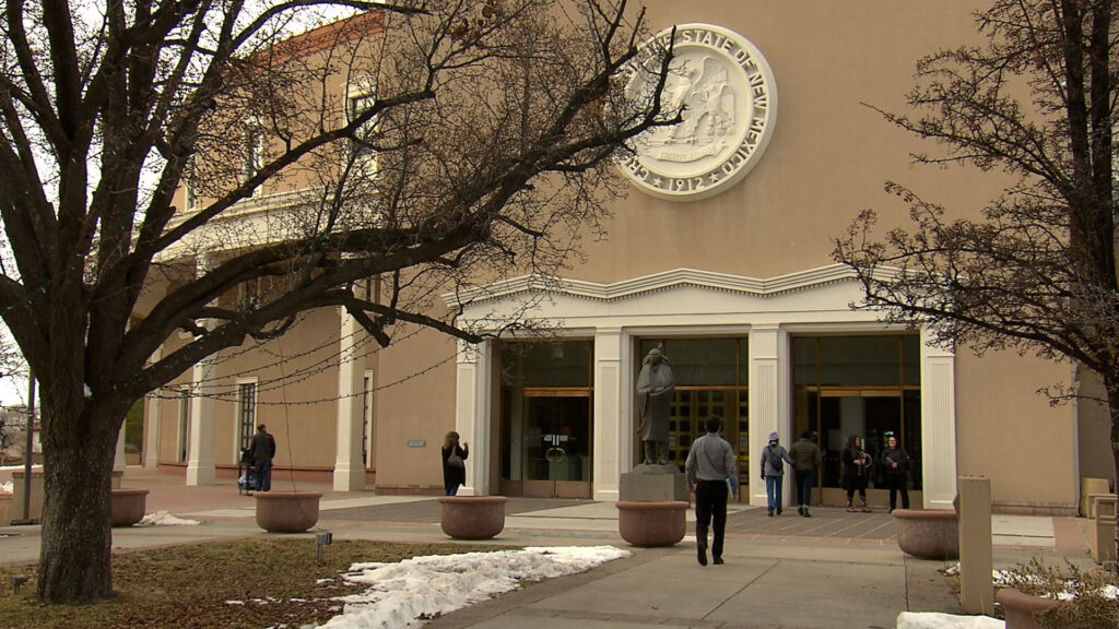 The front of a building with people walking in front of it.