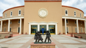 A statue of two people in front of a building.