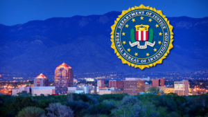 The fbi logo with a city and mountains in the background.