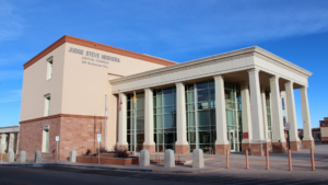 A building with columns and a blue sky.