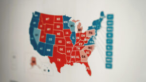 Map of the united states showing states color-coded in red and blue, focused on the midwest region, on a blurred background.