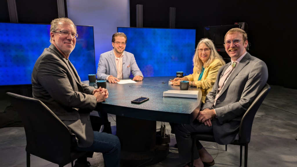 From left to right: Trip Jennings, Lou DiVizio, Dede Feldman and Daniel Williams sit at the roundtable at the KUNM station studio.