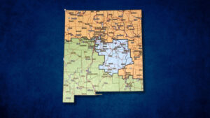 A color-coded map of New Mexico shows different regions divided by orange, green, and blue shaded areas, with cities and highways labeled.