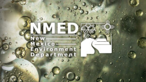 NMED New Mexico Environment Department logo is centered over a blurred background with bubbles and a mix of greenish and brownish hues.