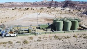 A large green tanks in a desert.