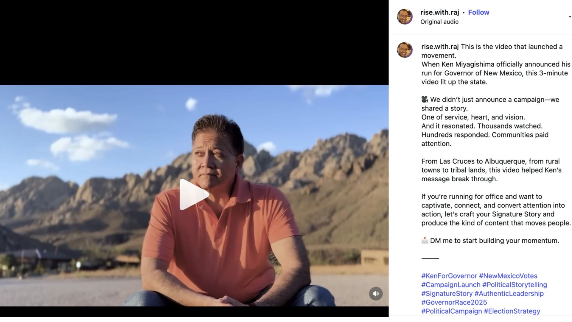 A man in a coral polo shirt sits outdoors with a mountain range and blue sky in the background.