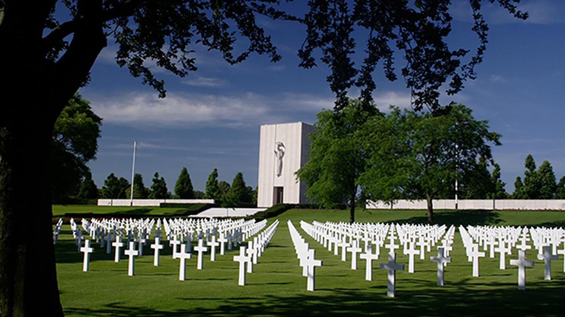 A military graveyard featuring dozens of white crosses.