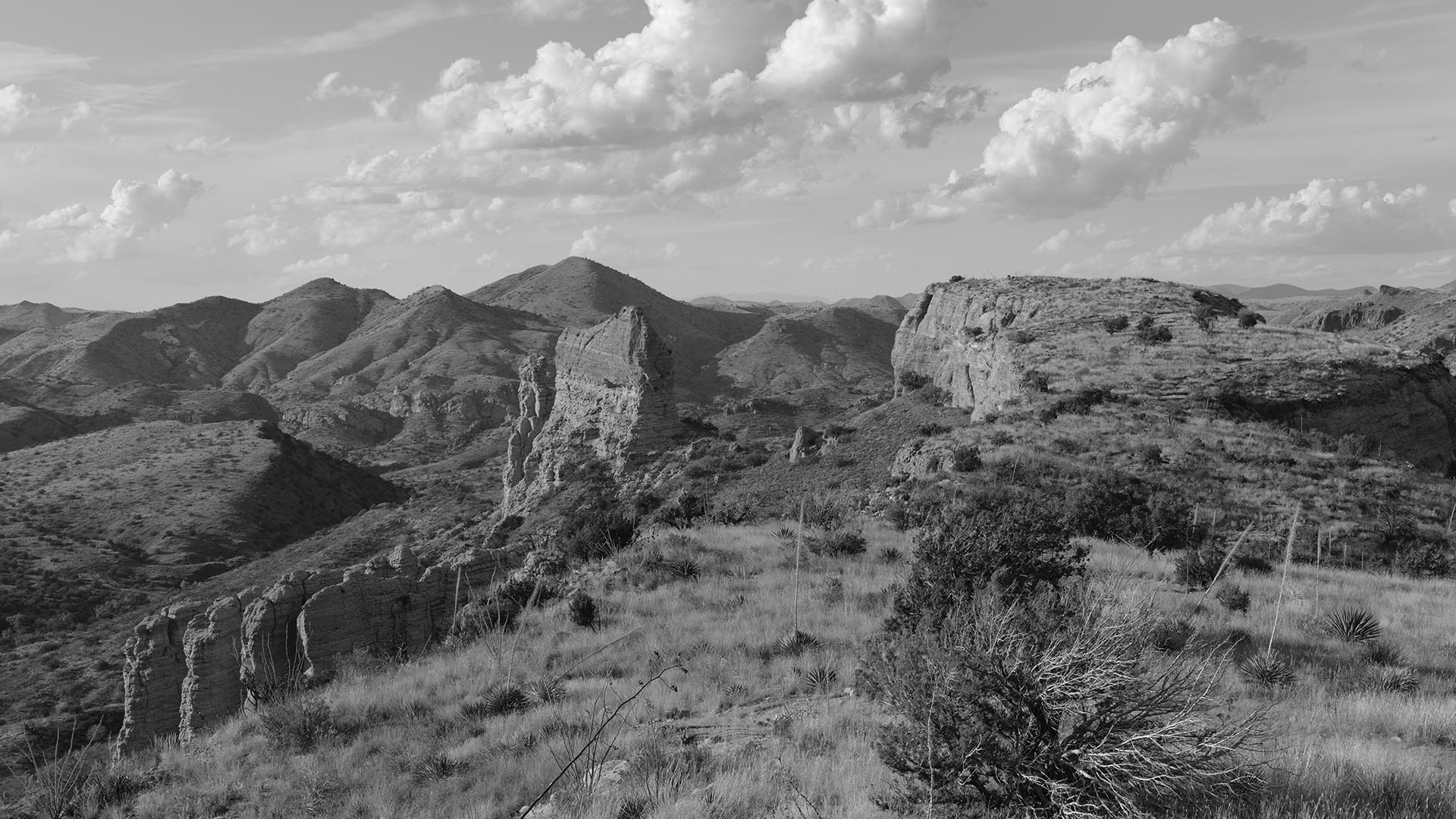 Black-and-white view of a rocky desert range.